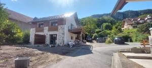 a house under construction on a street at APPARTEMENT 4 PERSONNES 100 metres du Lac jardin privé in Doussard