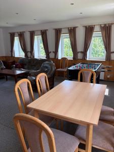 a living room with a table and a couch at Chata VISTA Strážné in Strážné