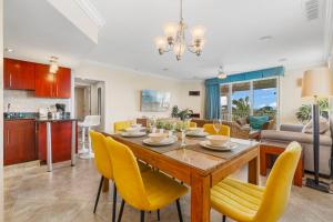 a dining room and living room with a table and chairs at Divi Village Condo 31 in Palm-Eagle Beach