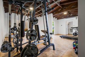 a gym with several exercise equipment in a room at Jardines del Mar 3 in Palm-Eagle Beach