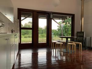 a kitchen with a table and some stools and a table at La Brebu 102 in Brebu Mînăstirei
