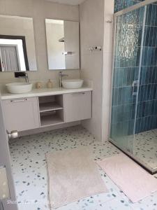 a bathroom with two sinks and a glass shower at Holiday Home Turkuaz in Oludeniz +22 photos