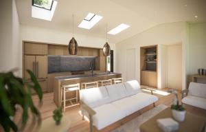 Una sala de estar con un sofá blanco y una cocina. en Será at Sandy Ridge - Brand New Modern WV Retreat, en Wardensville