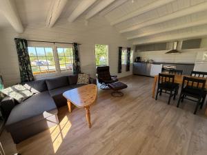 a living room with a couch and a table at Sjøholt Camping in Sjøholt