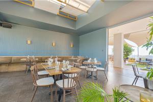 a restaurant with tables and chairs in a room at Menlyn Luxury Studio KingBed XL Free Parking 137 in Pretoria