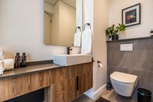 a bathroom with a sink and a toilet at Menlyn Luxury Studio KingBed XL Free Parking 137 in Pretoria +13 photos