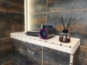 a bathroom shelf with a mirror and a comb and sticks at La La Loft in Bytom