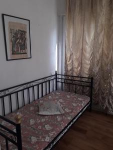 a bedroom with a bed with a bedspread on it at Apartment Magnolija in Jūrmala