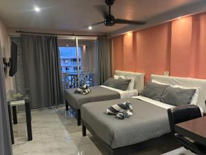 a living room with two beds and a couch at Cancun Plaza Condo Mexico in Cancún +157 photos