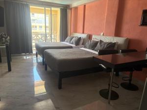 a hotel room with two beds and a couch at Cancun Plaza Condo Mexico in Cancún
