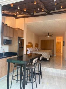 a kitchen and a bedroom with a bed and a table at Cancun Plaza Condo Mexico in Cancún