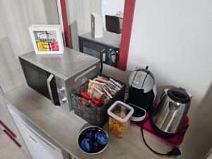 a counter with a coffee maker and a basket of food at Mare Fuori in Gonnesa