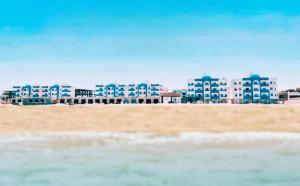 a view of a beach with buildings in the background at isis MARINA in Hurghada