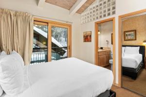 a bedroom with a large white bed and a balcony at Crestwood 3102 Standard 3 Bedroom Plus Loft in Snowmass Village +23 photos