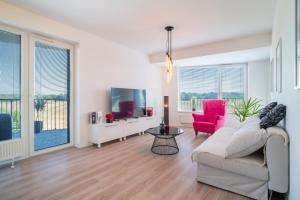 a living room with a couch and a tv at Modern beautiful apartment close to the center in Bratislava