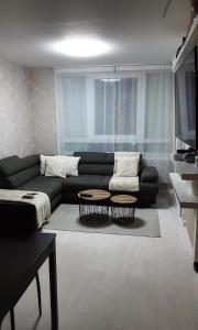 a living room with a couch and a table at Room Urban Chic in Reims