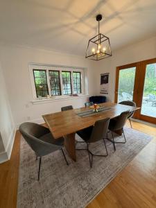 a dining room with a wooden table and chairs at 3 bedroom home next to downtown and medical mile in Grand Rapids