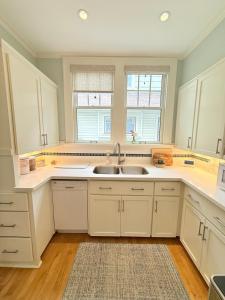a kitchen with white cabinets and a sink at 3 bedroom home next to downtown and medical mile in Grand Rapids