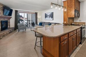 a kitchen and living room with a couch at Crestwood 3208 Premier 1 Bedroom in Snowmass Village
