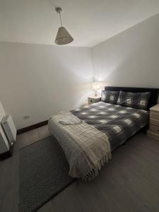 a bedroom with a bed and a lamp in it at Atlas Harbour Monkstown in Monkstown +21 photos