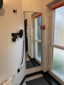 a mirror on the wall in a room at The Secret Maisonette Rochester in Rochester +27 photos