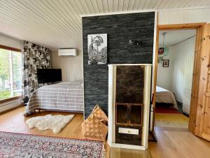 a bedroom with a bed and a brick wall at Lumossa Aurora Lakeside House in Rovaniemi