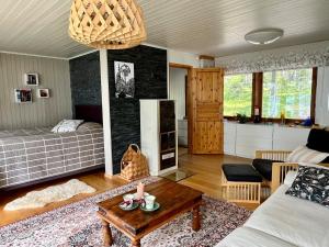 a living room with a bed and a table at Lumossa Aurora Lakeside House in Rovaniemi