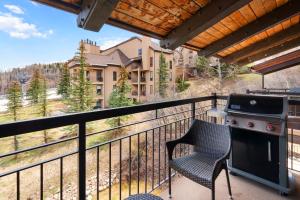 a patio with a grill and a chair on a balcony at Crestwood 3312 Standard 1 Bedroom Plus Loft in Snowmass Village