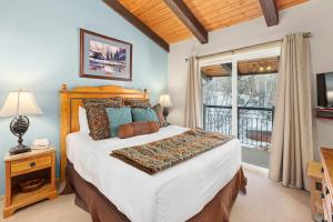 a bedroom with a large bed and a window at Crestwood 3313 Deluxe 1 Bedroom Plus Loft in Snowmass Village +19 photos