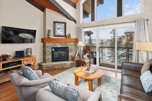 a living room with a fireplace and a tv at Crestwood 3313 Deluxe 1 Bedroom Plus Loft in Snowmass Village