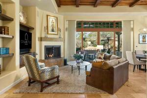 a living room with a couch and a fireplace at Tranquility at The Rocks Club/Troon in Scottsdale