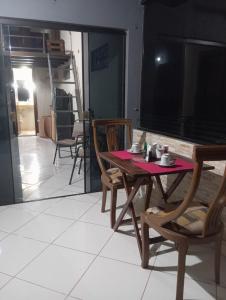 a table and chairs in a room with a television at ViDa in Luque