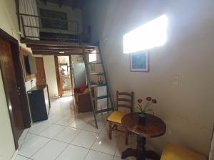 a living room with a table and a room with a staircase at ViDa in Luque