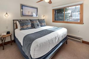 a bedroom with a large bed with a window at Crestwood 3208 Premier 1 Bedroom in Snowmass Village +16 photos