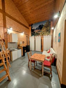 a room with a table and chairs and a kitchen at la caseta viva in Olvan +17 photos