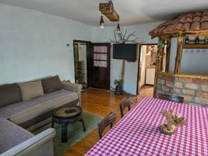 a living room with a couch and a table at Seosko domaćinstvo „GABAR” in Ćuštica +49 photos