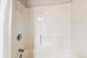 a white bathroom with a shower with a sink at Water Street Condos Unit 808 in Wilmington +10 photos