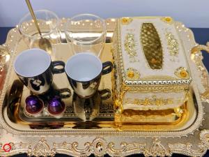 a gold tray with two cups and glasses on it at Royal Lux in Sagunto
