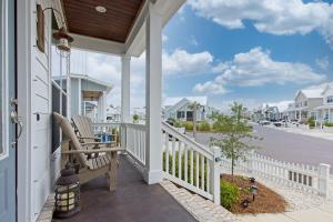 a porch with a rocking chair on a house at Endless Summer in Gulf Shores