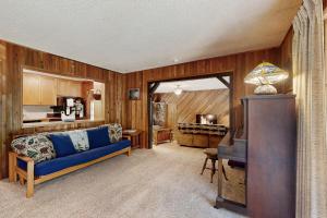 a living room with a blue couch and a television at Hood Hideout in Welches