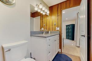 a bathroom with a toilet and a sink and a mirror at Hood Hideout in Welches +14 photos