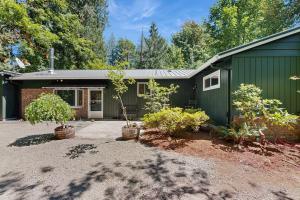 a green house with plants in front of it at Hood Hideout in Welches