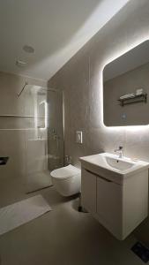 a bathroom with a sink and a toilet and a mirror at Donna in Ulcinj +113 photos