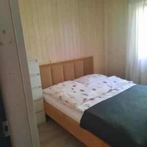 a bedroom with a bed and a dresser at Domek LEŚNICZÓWKA Gorzewo in Gorzewo +16 photos