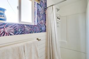 a bathroom with a shower and a shower curtain at Boho Bungalow with Hot Tub 16 Mi to Joshua Tree NP in Sunfair Heights