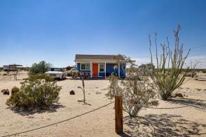 a blue house in the middle of the desert at Boho Bungalow with Hot Tub 16 Mi to Joshua Tree NP in Sunfair Heights +19 photos