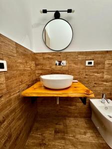 a bathroom with a white sink and a mirror at Marigiò in Menfi +22 photos