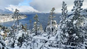 a view of a lake with snow covered trees at Aucapillan in San Carlos de Bariloche +9 photos