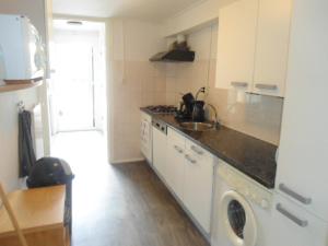 a kitchen with a sink and a washing machine at Halte71 in Zandvoort