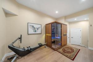 a room with a treadmill and a glass shower at Pipers Paradise in Beech Mountain